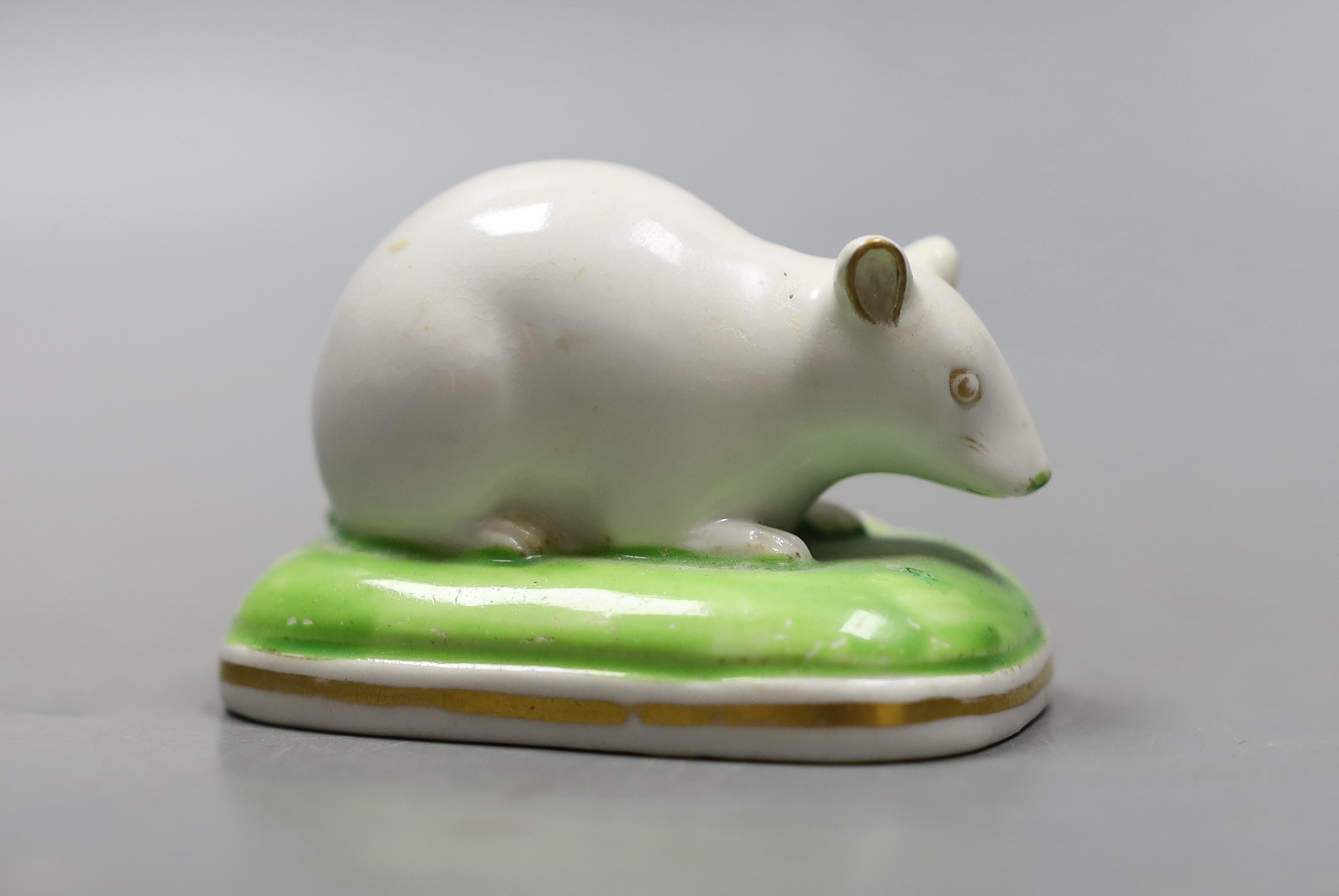 A Derby porcelain figure of a recumbent white mouse, c.1825-35, unmarked, 6.5cm, cf. D. G. Rice, English Porcelain Animals of the 19th century, colour plate 28b., Provenance- Dennis G Rice collection